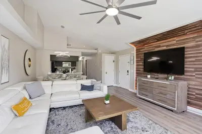 a living room with a white couch and a flat screen tv at 2022 Royal Bay #94 in Kissimmee