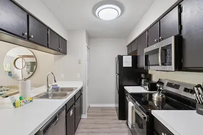 a kitchen with black cabinets and a sink at 2022 Royal Bay #94 in Kissimmee