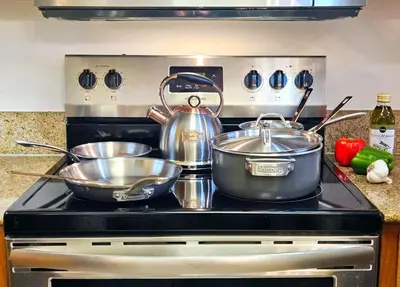 two pots and pans on a stove in a kitchen at Stunning waterfront Views 1 mile to Disney 2 bath in Orlando
