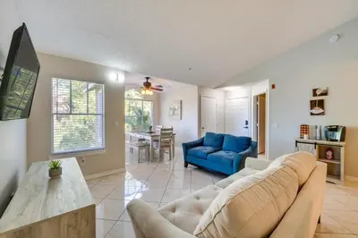 a living room with a couch and a blue sofa at Villa Velera in Kissimmee