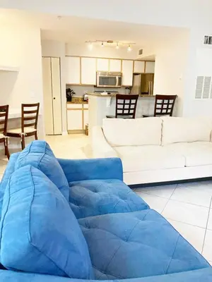 a living room with a blue bean bag couch at Villa Velera in Kissimmee