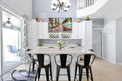 a kitchen with a table and four chairs at Emerald Island Resort 6 Bed Pool & Spa villa in Kissimmee