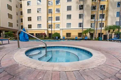 a small pool in a courtyard in front of a building at Harry Potter Stay Near Universal in Orlando