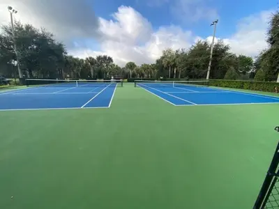 a tennis court with two tennis courts at Palm Tree Paradise 3 bedroom condo at Windsor Hills close to Disney in Orlando