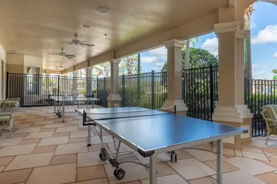 a room with two ping pong tables on a balcony at Palm Tree Paradise 3 bedroom condo at Windsor Hills close to Disney in Orlando
