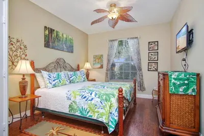 a bedroom with a bed and a ceiling fan at Palm Tree Paradise 3 bedroom condo at Windsor Hills close to Disney in Orlando