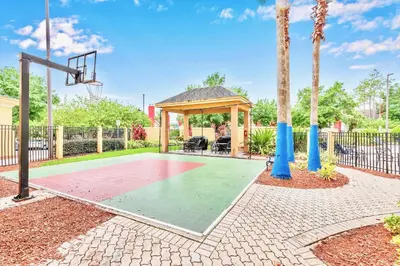 a basketball court with a gazebo and a basketball hoop at Modern Condo close to Disney with Arcade and BBQ Grill in Orlando