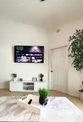 a living room with a flat screen tv on the wall at Family Home, Near Disney-Private pool, Spacious 3BR Retreat in Orlando