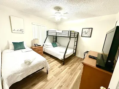 a bedroom with a bunk bed and a television at Family Home, Near Disney-Private pool, Spacious 3BR Retreat in Orlando