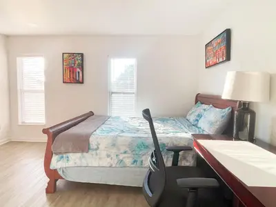 a bedroom with a bed and a desk with a desk at Happy Home in Orlando