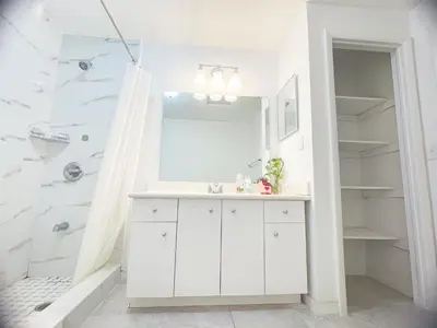 a white bathroom with a sink and a shower at Happy Home in Orlando