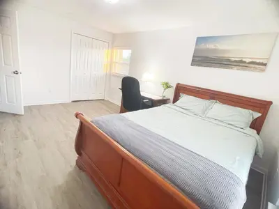 a bedroom with a bed and a desk with a chair at Happy Home in Orlando