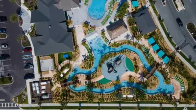 an aerial view of a pool at a resort at Family Stylish 4BR Pool Townhome Storey Lake in Kissimmee