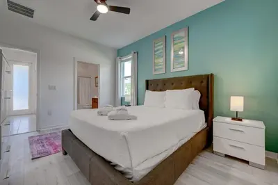 a bedroom with a large bed and a blue wall at Bellavida Resort Retreat with Private Pool in Kissimmee