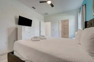 a bedroom with a large bed with a flat screen tv at Bellavida Resort Retreat with Private Pool in Kissimmee