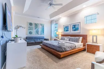 a bedroom with a bed and a couch at Elsa's Enchanting Escape just 15 minutes to Disney in Kissimmee