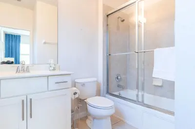 a bathroom with a shower and a toilet and a sink at Elsa's Enchanting Escape just 15 minutes to Disney in Kissimmee