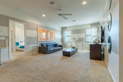 a living room with a couch and a table at Elsa's Enchanting Escape just 15 minutes to Disney in Kissimmee