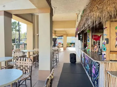 a restaurant with tables and chairs and a bar at 3 Bedroom 2 Bathroom Villas At Seven Dwarfs 30-105 in Kissimmee