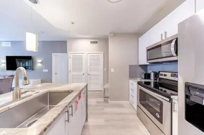 a kitchen with a sink and a stove at 3 Bedroom 2 Bathroom Villas At Seven Dwarfs 30-105 in Kissimmee