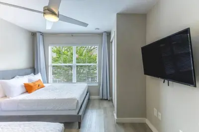 a bedroom with two beds and a flat screen tv at 3 Bedroom 2 Bathroom Villas At Seven Dwarfs 30-105 in Kissimmee