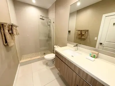 a bathroom with a sink and a toilet and a mirror at Luxurious 4bed Villa Just 10 Minutes from Disney! Private BBQ in Orlando