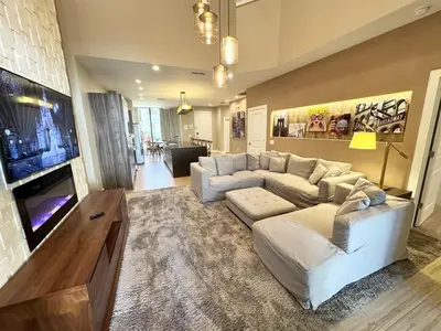 a living room with a couch and a tv at Luxurious 4bed Villa Just 10 Minutes from Disney! Private BBQ in Orlando