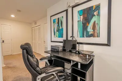 a home office with a desk and a chair at 6BR Fun Villa – Game Room, Pool, Near Parks in Kissimmee