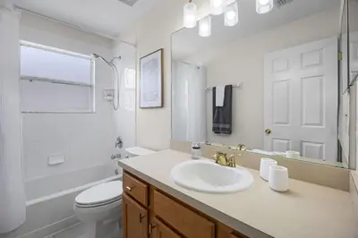 a white bathroom with a sink and a toilet at Luxurious Family Resort Getaway in Kissimmee