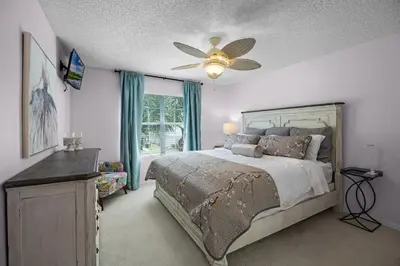 a bedroom with a bed and a ceiling fan at Luxurious Family Resort Getaway in Kissimmee