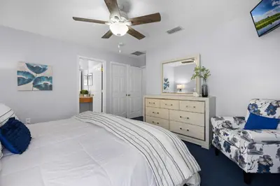 a bedroom with a bed and a ceiling fan at Luxurious Family Resort Getaway in Kissimmee