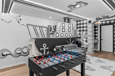 a living room with a foosball table in the middle at Brand New 05 Bedrooms At Windsor Cay in Orlando