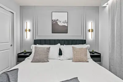 a white bedroom with a large white bed with pillows at Brand New 05 Bedrooms At Windsor Cay in Orlando