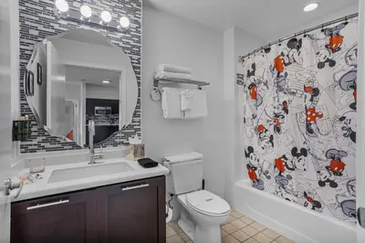 a bathroom with a toilet and a sink and a shower curtain at Spacious Pet Friendly in Orlando