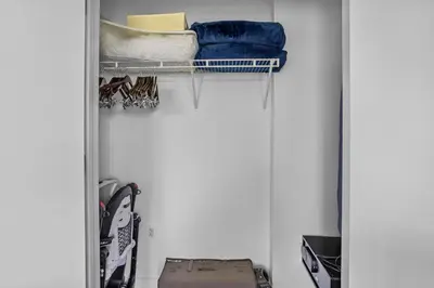 a closet with a door open with clothes at Spacious Pet Friendly in Orlando