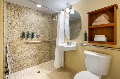 a bathroom with a shower and a toilet and a sink at Hilton Vacation Club Cypress Pointe Orlando in Orlando