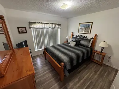 a bedroom with a bed and a window at Relaxing 3BR/2BA Home - Just 15 Minutes from Disney! in Kissimmee
