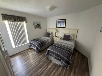 a bedroom with two beds and a window at Relaxing 3BR/2BA Home - Just 15 Minutes from Disney! in Kissimmee