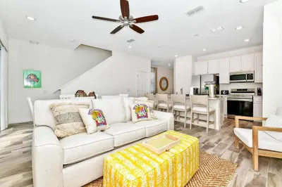 a living room with a white couch and a table at Best Margaritaville Villa Near Disney World in Orlando