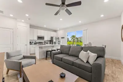 a living room with a couch and a ceiling fan at Waves of Relaxation - For 8 in Orlando