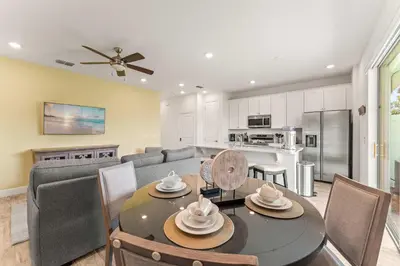 a kitchen and living room with a table and chairs at Waves of Relaxation - For 8 in Orlando