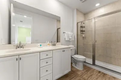 a bathroom with a toilet and a sink and a shower at Waves of Relaxation - For 8 in Orlando