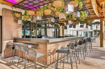 a bar with a row of stools in a restaurant at Waves of Relaxation - For 8 in Orlando