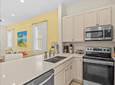 a kitchen with a sink and a microwave at Bikinis and Martinis - For 6 in Orlando
