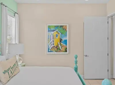 a bedroom with a bed with a painting on the wall at Bikinis and Martinis - For 6 in Orlando