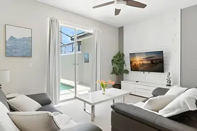 a living room with a couch and a table at Magia 4Q c/ Piscina e Quartos Temáticos Disney in Kissimmee