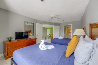 a bedroom with two beds with swans on them at 2 Mi to Disney and Old Town Resort Condo with Perks in Orlando