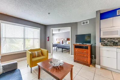 a living room with a couch and a tv at 2 Mi to Disney Resort Condo with Pool Access in Orlando