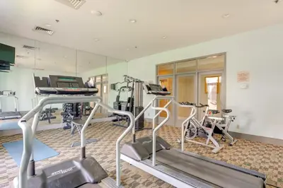 a gym with treadmills and ellipticals in a room at 2 Mi to Disney Resort Condo with Pool Access in Orlando