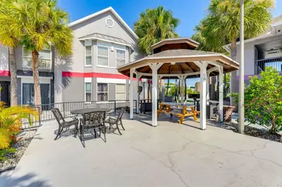a patio with a gazebo and a table and chairs at 2 Mi to Disney Resort Condo with Pool Access in Orlando